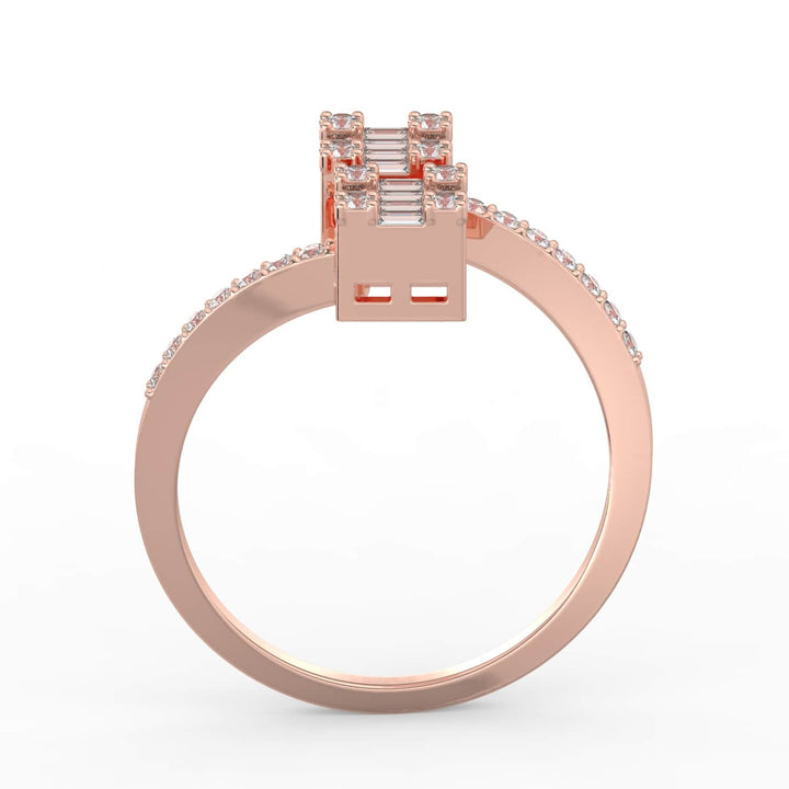 A modern diamond ring featuring two square clusters of baguette and round-cut diamonds on a pavé-set bypass band.