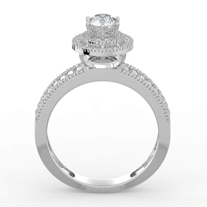 A diamond ring with a round center stone, surrounded by a double halo of pavé-set diamonds, and a band featuring a row of alternating baguette and round diamonds.